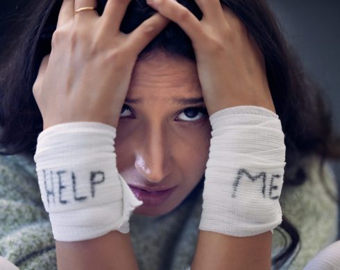 Depression, wrist and woman with help on bandage for suicide, self harm or person in dark mental health crisis. Portrait, girl and injury from depressed accident, problem or mistake in cutting wrists.